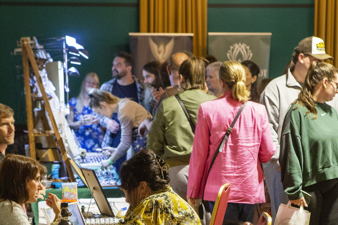 Visitors browsing exhibitor stalls in the busy hall at a Rosemary Douglas Mind Body Spirit event