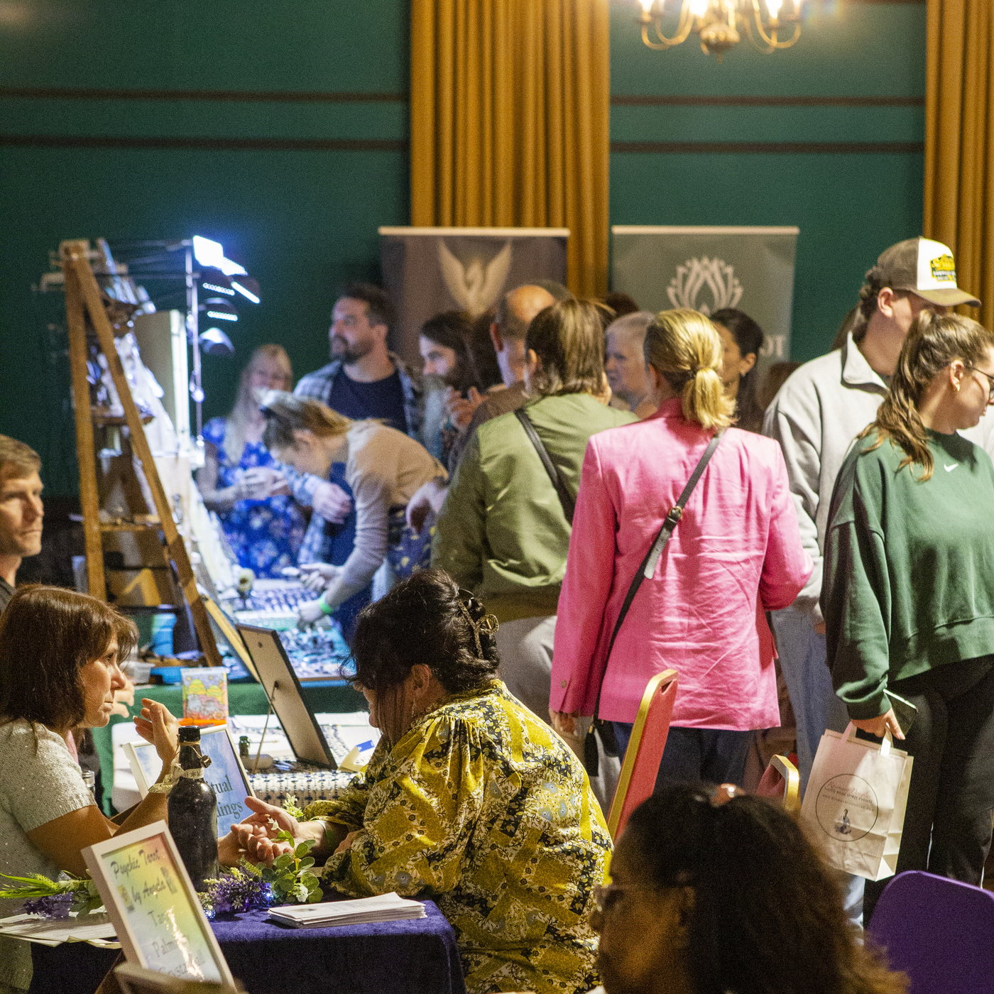 Visitors browsing exhibitor stalls in the busy hall at a Rosemary Douglas Mind Body Spirit event